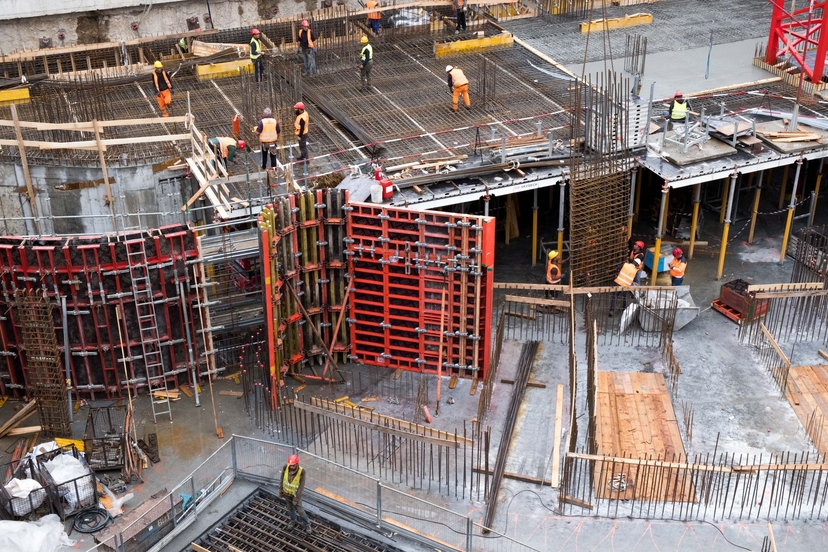 Construction crews working across a commercial concrete deck