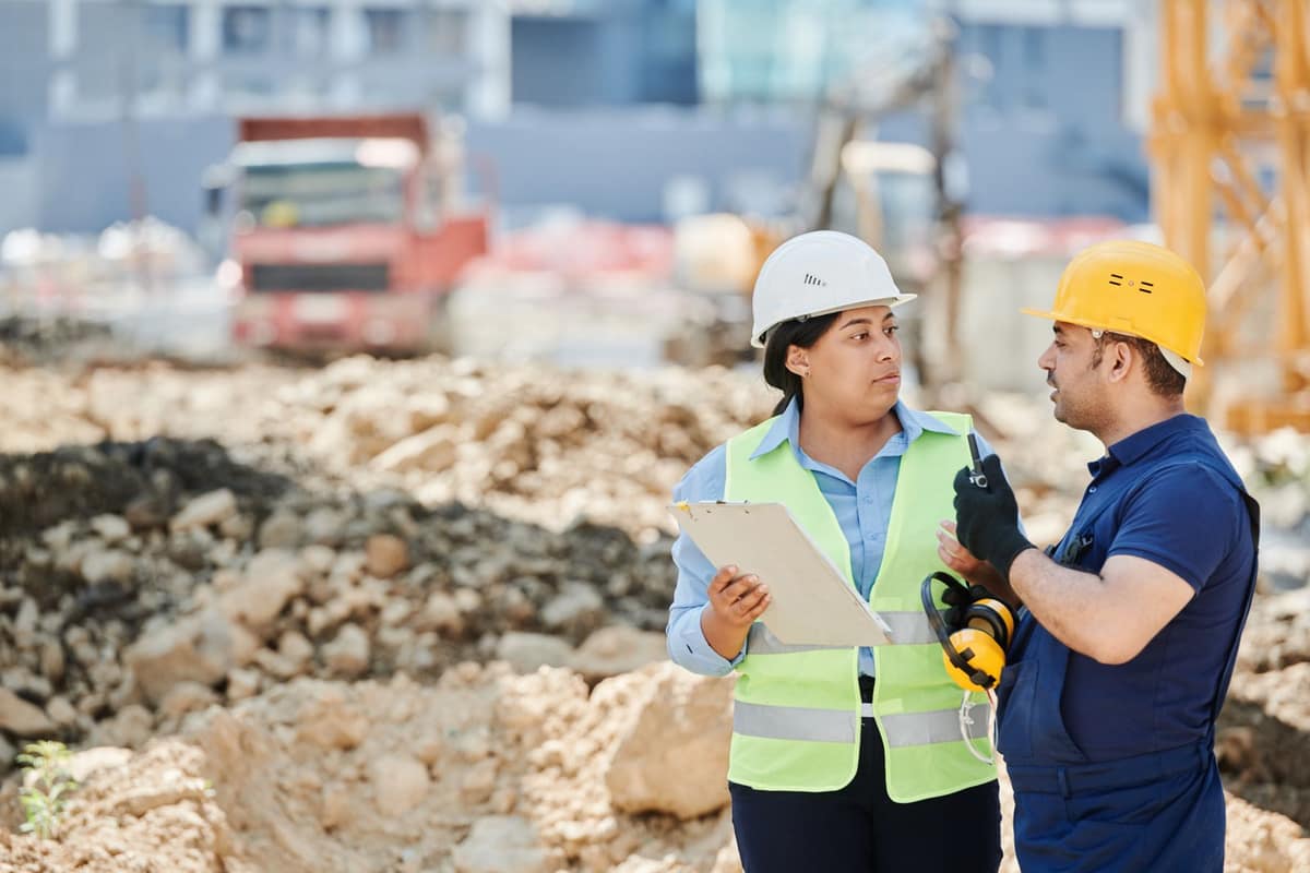 A site supervisor and a contractor reviewing work on a commercial site